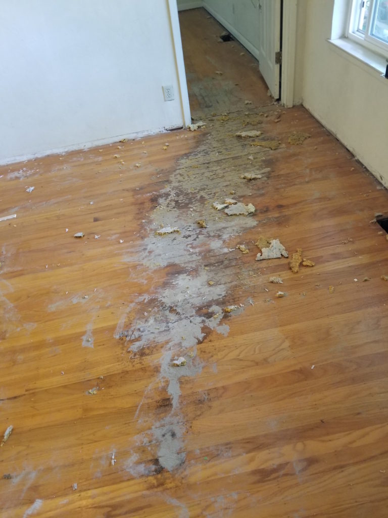 Before repairs were performed to this damaged wood flooring.